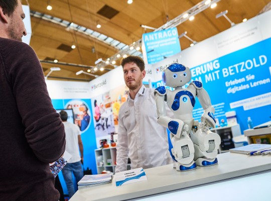 Ein Aussteller präsentiert einen Roboter 