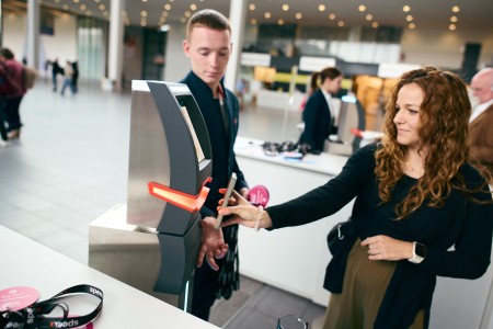 A visitor scans his ticket at the entrance to LEARNTEC.