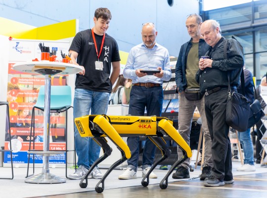 An exhibitor presents a robot 