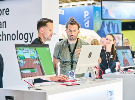 Two experts talk at an exhibition stand 