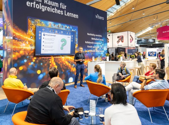 Ein Experte hält einen Vortrag an einem Messestand
